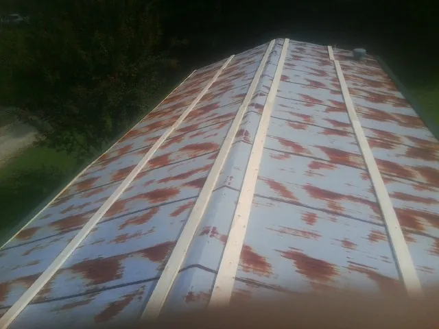 Rusted metal roof panels with new wood purlins before replacement — Storm Damage Roof Repair in Gooding by Roofing Brothers